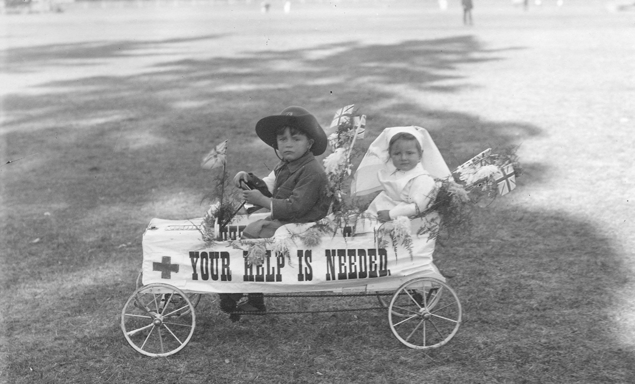 Two small children seated in a toy car [PRG 280/1/27/130]