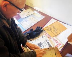 Andrew Wilson looking through the display featuring Nunga News. 